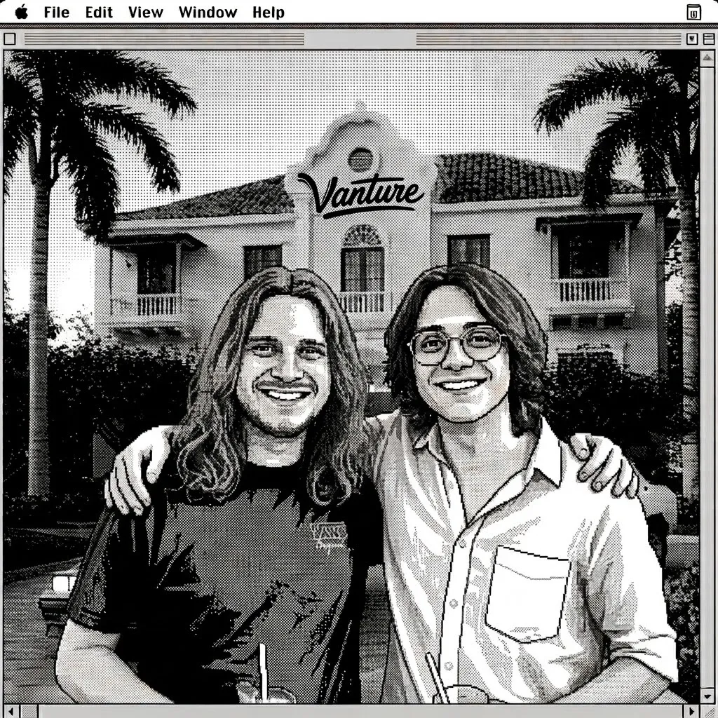 Two members of the team outside a building with a Vanture sign